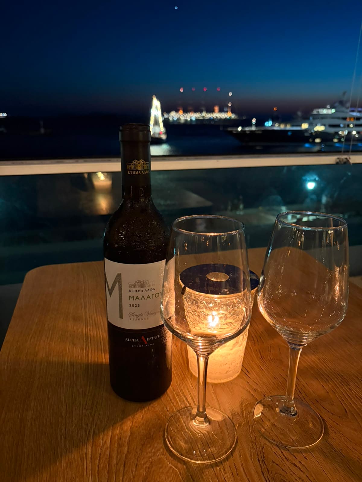 Wine glasses on a table at golden hour in Mykonos